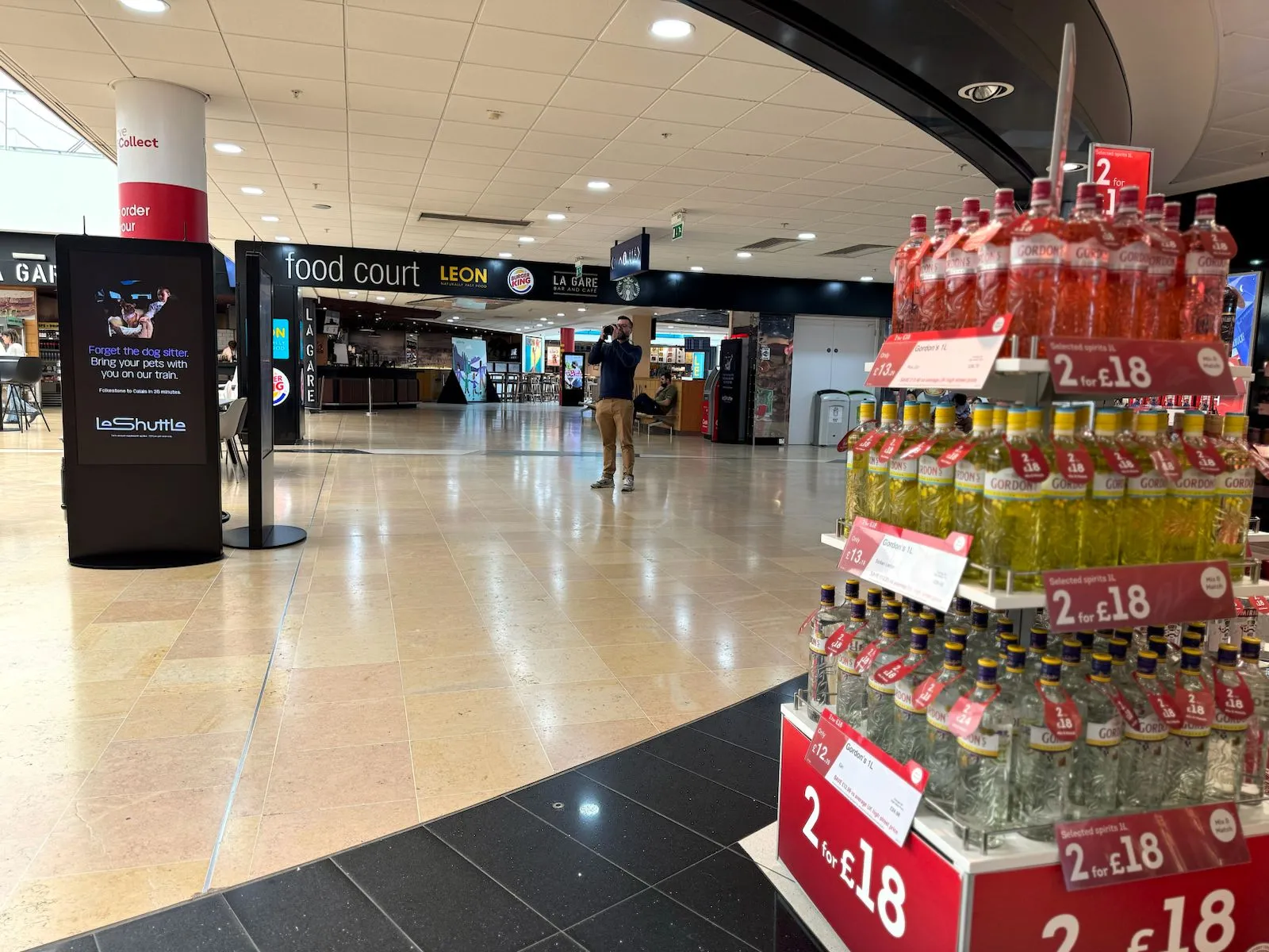 A portrait digital screen in the LeShuttle terminal food court