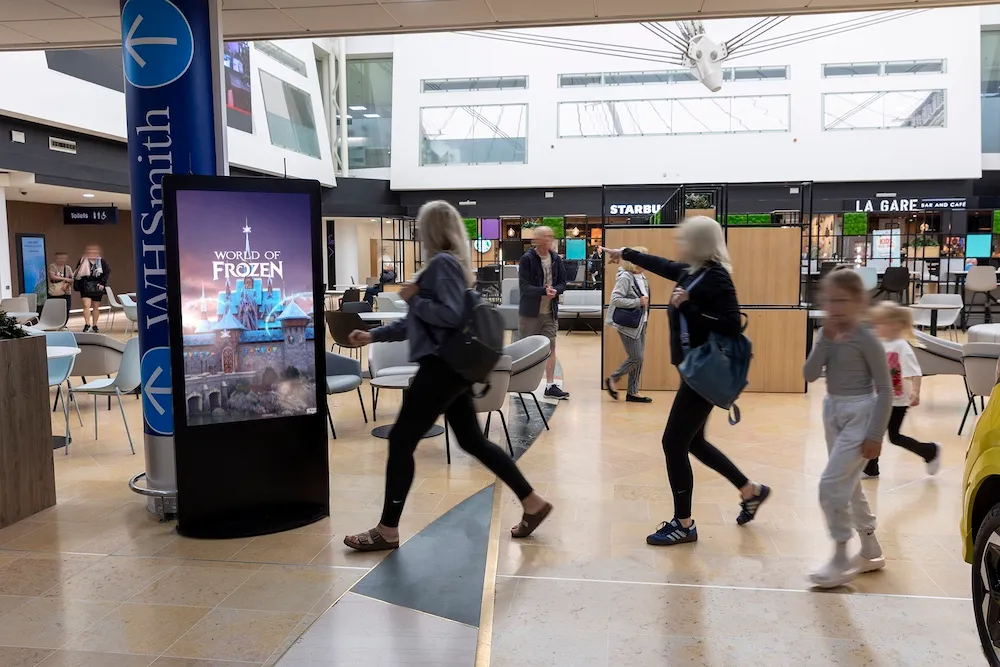Disney World of Frozen advertising on a digital screen at the UK LeShuttle terminal