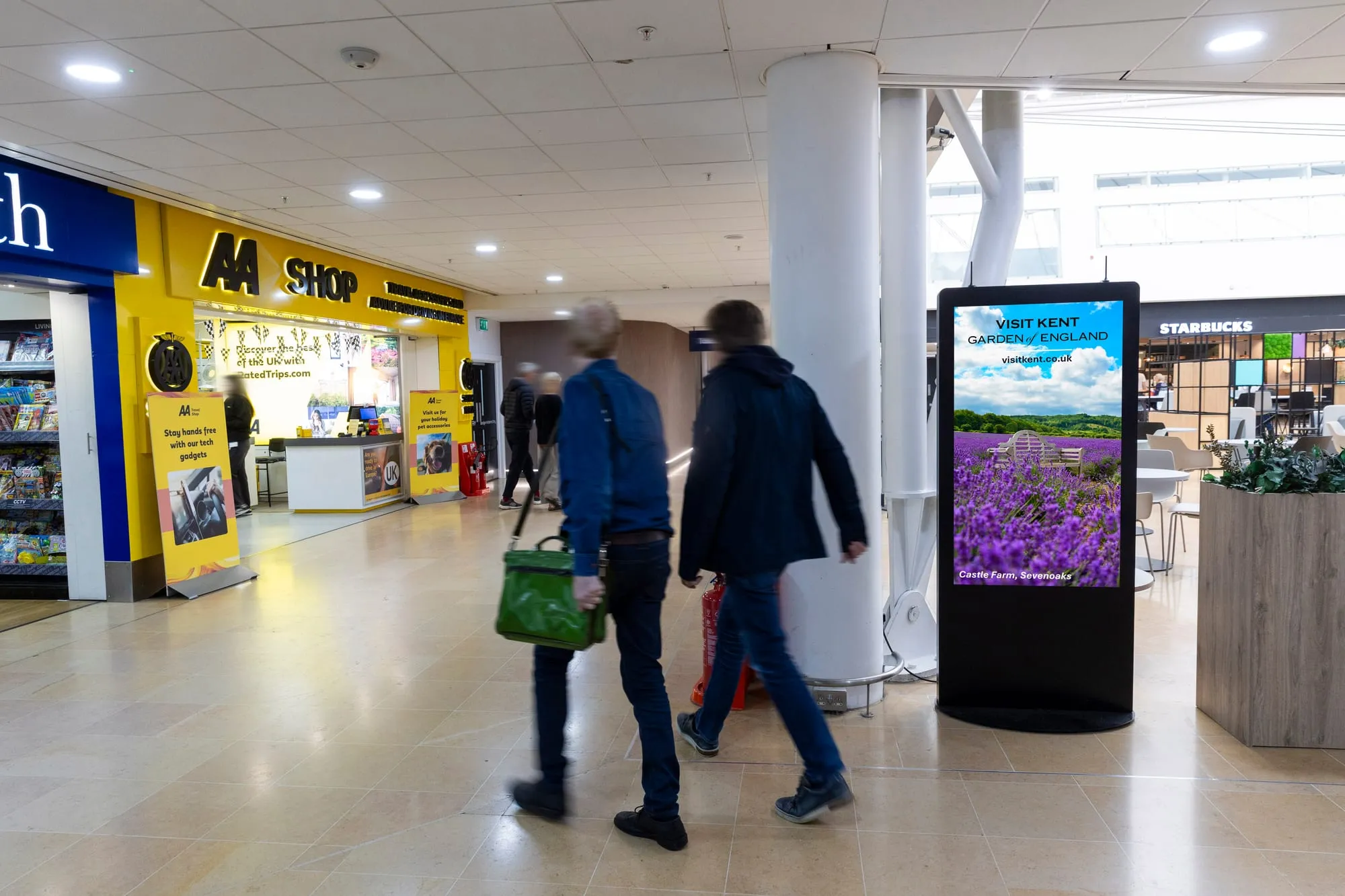 A Visit Kent campaign on a portrait D6 screen at the LeShuttle terminal